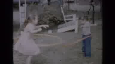 Minnesota USA (1958): Two Girls Play With Pink Hula Hoops On A Clear Day
