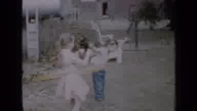 Minnesota USA (1958): A Boy And A Girl Playing In The Yard With Hula Hoops