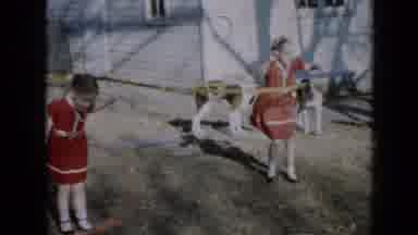 Minnesota USA (1958): Two Kids Hula Hooping While Dogs Play Behind Them