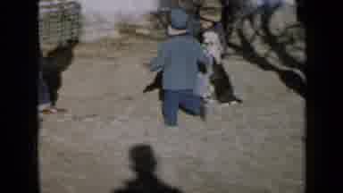 Minnesota USA (1958): Seventies Toddler Running And His Family Playing With A Dog