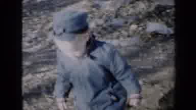 Minnesota USA (1958): A Bundled Child Wobbles Back And Forth As He Walks Then