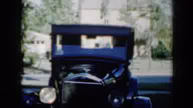 Minnesota USA (1958): Ford Model T Is Displayed As A New Vehicle Passes In The