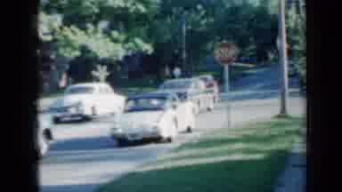 Minnesota USA (1958): Two Cars Run A Traffic Sign While A Little Girl Keeps Her