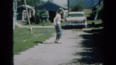 Minnesota USA (1958): Girl Wearing Jeans And Bobby-Socks On Gravel Driveway