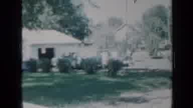 Minnesota USA (1958): Garage Is Seen In Distance Then Girl With Hoop And Man Both