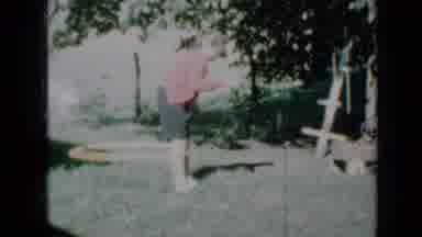 Minnesota USA (1958): Girl Wearing Red And Using A Hula Hoop Around Her Calves