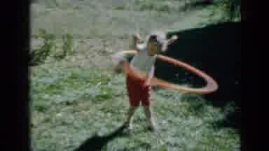 Minnesota USA (1958): Little Blonde Haired Girl Playing With Hula Hoop On Sunny
