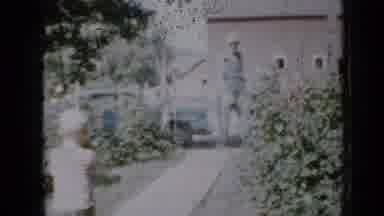 Minnesota USA (1958): Woman Goes Out Gate Man Comes In Gate Toddler Walks Back And