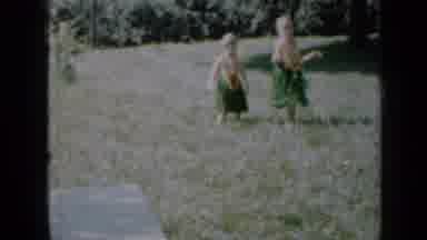 Minnesota USA (1958): Two Blonde Children Hula-Dancing In Grass Skirts And Leis
