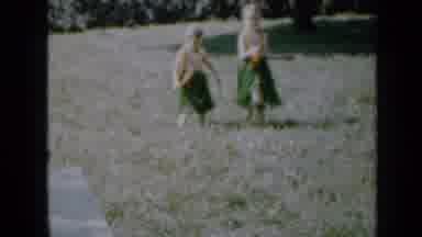 Minnesota USA (1958): Two Girls With Plant Skirts And Hawaiian Necklaces Dancing