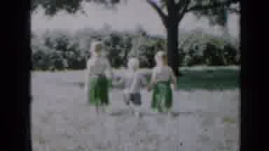 Minnesota USA (1958): An Older Girl A Little Boy And A Middle Girl Walk Hand In