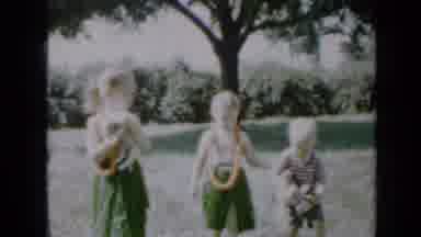 Minnesota USA (1958): Young White Children Wearing Grass Skirts In The Tropics