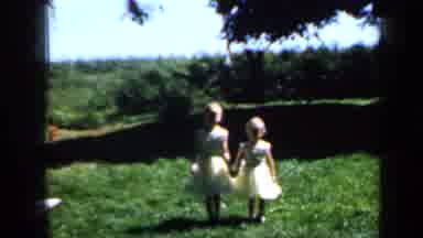 Minnesota USA (1958): Two Little Girls Holding Hands Outside Walking In Beautiful