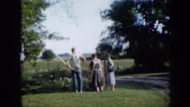 Minnesota USA (1958): A Man And Two Women Standing By A Fence Then That Man Walks