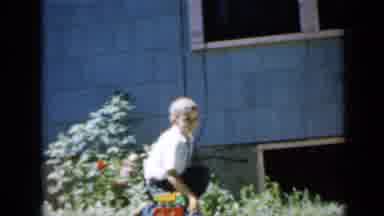 Minnesota USA (1958): Big Boy On His Knees Pushes Toy As Little Boy Follows Doing