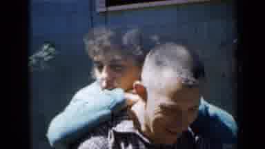 Minnesota USA (1958): A Family And Their Children Playing Outside Of Their Home