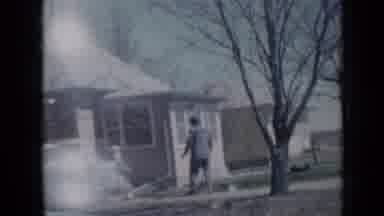 Minnesota USA (1958): Four People Walking Outside A House And Stopping To Stand