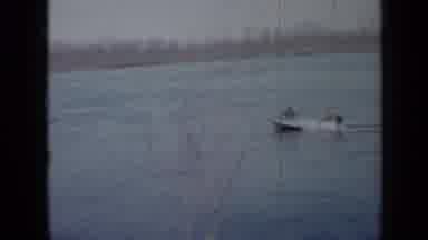 Minnesota USA (1958): Motorized Boat Going Down A Lake With Two People In It
