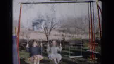 Minnesota USA (1958): Two Little Girls In Dresses Swing Back And Forth On Back