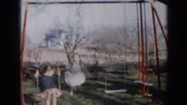 Minnesota USA (1958): Two Children Swinging On Their Swingset