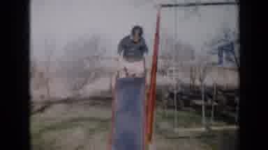 Minnesota USA (1958): Two Kids Going Down A Slide In Playground