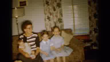Minnesota USA (1958): Family Sitting On A Sofa And Kid Walking Around Living Room