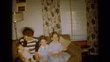 Minnesota USA (1958): Family Sitting On A Sofa Then Women Walks In And Sits With