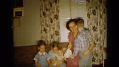 Minnesota USA (1958): Family Gathered Around The Couch Hugging Each Other