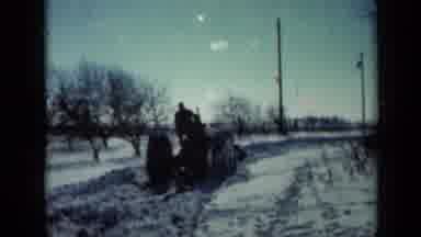 Minnesota USA (1958): A Person Driving A Tractor In The Snow And Then What Looks