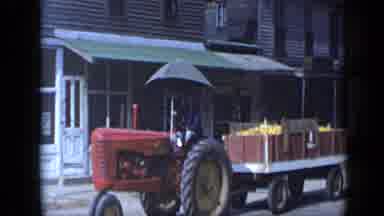 Aledo Texas (1959): Tractor Pulling Wagon Of Produce Along The Street