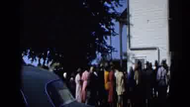 Aledo Texas (1959): Duck Quacks On A Yellow Blanket As A Crowd Of People Waits