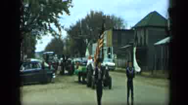 Aledo Texas (1959): People Marching Down The Road Waving Flags With Tractors