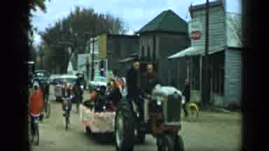 Aledo Texas (1959): Children On Bicycles Weave Between Floats Ahead Of Someone On