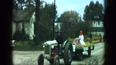 Aledo Texas (1959): Man Driving A Tractor Down A Gravel Road With A Statue On The