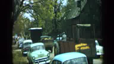 Aledo Texas (1959): Vehicles Fill A Small House Lined Street As People Exit The