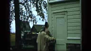 Aledo Texas (1959): Two People Getting In A Home While Looking Back At Something