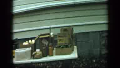 Aledo Texas (1959): White Table Loaded With Brown Boxes On A Clear Day