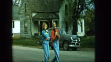 Aledo Texas (1959): Young Girls Walking Through A Neighborhood Street While One Of