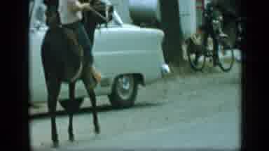 Aledo Texas (1959): People Go Up A Street Then A Chevy And Many Bikes Come Down