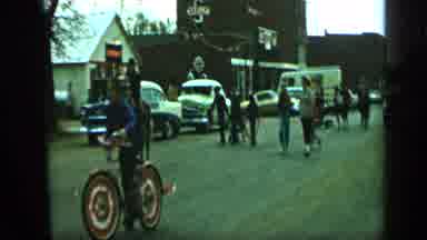 Aledo Texas (1959): Adults Walking And Kids Riding On Bicycles Make Their Way Thru