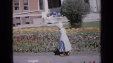 Iowa USA (1959): Child Walks Around Garden In The Middle Of Spring Outside Of Home