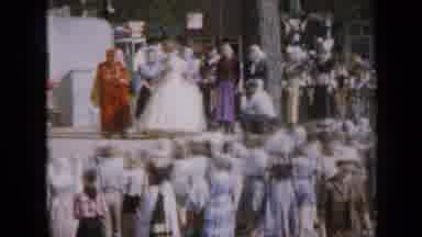Iowa USA (1959): A Crowd Of Women And Children Gather Around The Stage In A Nearby