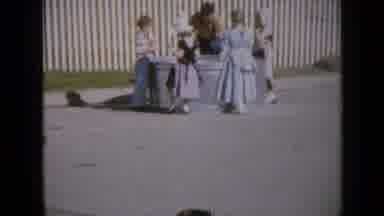 Iowa USA (1959): Little Girls Gather Around A Big Boy While Actors Perform Their