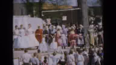 Iowa USA (1959): Procession Woman Outside Dress Ceremony Trees Dresses Stage Men