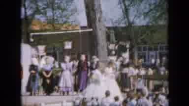 Iowa USA (1959): Women Walking Around Outside In Dresses At A Carnival Maybe