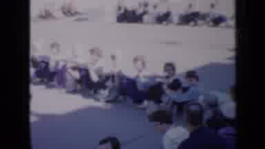 Iowa USA (1959): Ladies In Costumes Sit In A Very Straight Line On The Ground