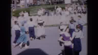 Iowa USA (1959): Large Group Of Women Dancing In Public Location