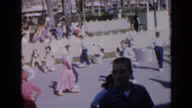Iowa USA (1959): People Dancing In Unison On Street As Crowd Watches