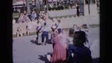 Iowa USA (1959): Tons Of People Dancing In Unison In A Parade As People Watch