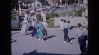 Iowa USA (1959): Couples In Period Dress Dance A Folk Dance In Front Of A Street